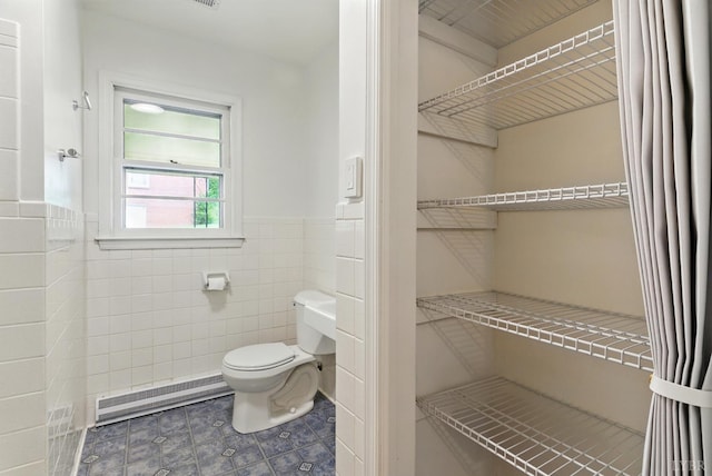 102 SE St, Brookneal, VA 24528 - bathroom with baseboard heating, tile patterned flooring, a wainscoted wall, and tile walls