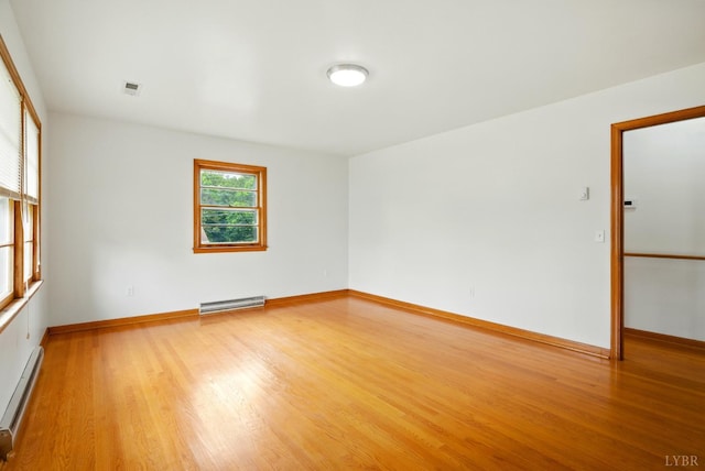 102 SE St, Brookneal, VA 24528 - spare room with baseboard heating, a baseboard heating unit, and light wood-style floors