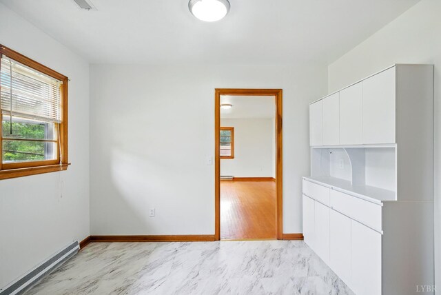 102 SE St, Brookneal, VA 24528 - spare room featuring a baseboard heating unit and light marble finish floors