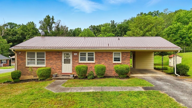 102 SE St, Brookneal, VA 24528 - view of front of home with driveway, a front lawn, brick siding, and a carport