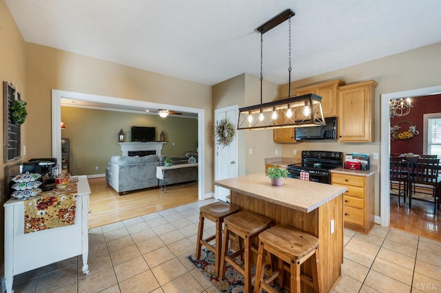 116 Wyndsong Pl, Lynchburg, VA 24502 - kitchen featuring black appliances, light countertops, light tile patterned floors, and light brown cabinetry