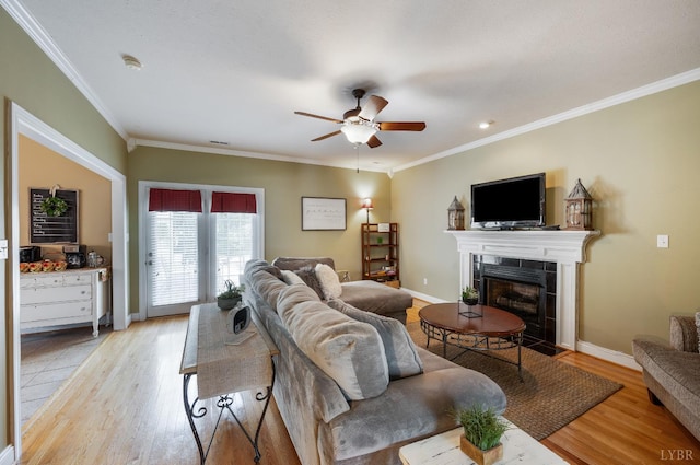116 Wyndsong Pl, Lynchburg, VA 24502 - living area featuring light wood-style flooring, ceiling fan, ornamental molding, and a tiled fireplace