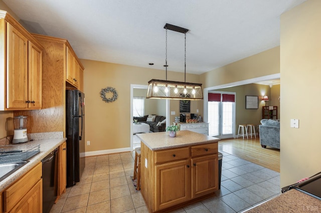 116 Wyndsong Pl, Lynchburg, VA 24502 - kitchen featuring black appliances, light tile patterned flooring, light countertops, and a center island