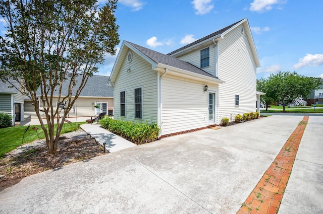 116 Wyndsong Pl, Lynchburg, VA 24502 - view of side of property featuring roof with shingles, a patio area, and driveway