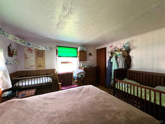 8288 Red House Rd, Phenix, VA 23959 - bedroom with a textured ceiling, wooden walls, and carpet floors