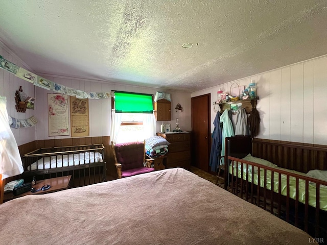 8288 Red House Rd, Phenix, VA 23959 - bedroom featuring a textured ceiling, wood walls, and carpet flooring