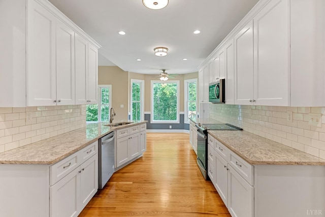 1290 Ivy Creek Dr, Forest, VA 24551 - kitchen featuring appliances with stainless steel finishes, light wood finished floors, white cabinets, recessed lighting, and decorative backsplash