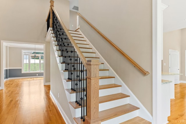 1290 Ivy Creek Dr, Forest, VA 24551 - stairs featuring wood finished floors and a chandelier