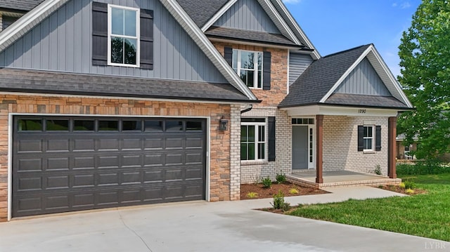 1290 Ivy Creek Dr, Forest, VA 24551 - view of front of home with board and batten siding, roof with shingles, concrete driveway, an attached garage, and brick siding