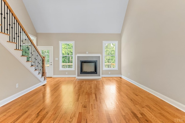1290 Ivy Creek Dr, Forest, VA 24551 - unfurnished living room with light wood finished floors, high vaulted ceiling, stairs, and a fireplace