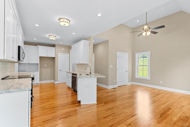 1290 Ivy Creek Dr, Forest, VA 24551 - kitchen with stainless steel appliances, ceiling fan, a peninsula, white cabinetry, and decorative backsplash