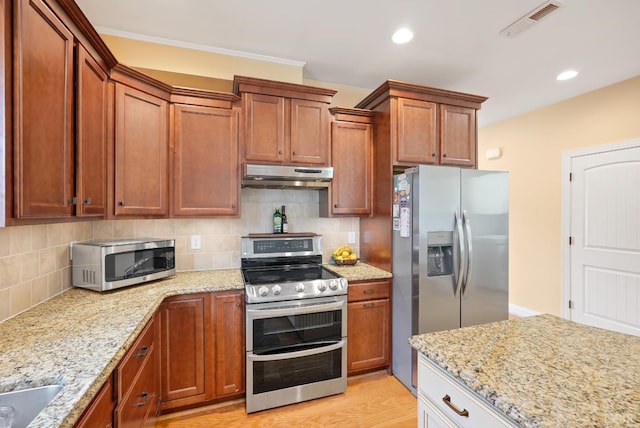 403 Cornerstone St, Lynchburg, VA 24502 - kitchen with stainless steel appliances, under cabinet range hood, backsplash, light stone countertops, and recessed lighting