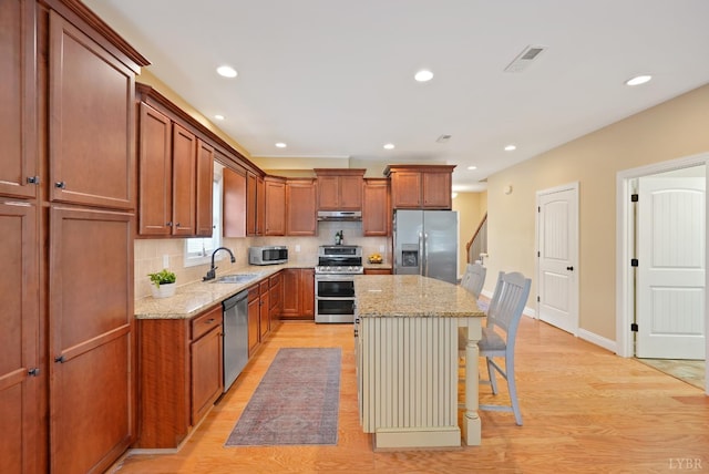 403 Cornerstone St, Lynchburg, VA 24502 - kitchen with stainless steel appliances, under cabinet range hood, a center island, light stone countertops, and recessed lighting
