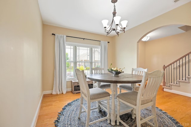 403 Cornerstone St, Lynchburg, VA 24502 - dining area featuring arched walkways, a chandelier, light wood-type flooring, and stairway