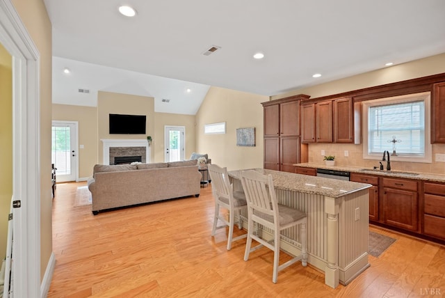 403 Cornerstone St, Lynchburg, VA 24502 - kitchen with stainless steel dishwasher, light stone countertops, vaulted ceiling, healthy amount of natural light, and a breakfast bar area