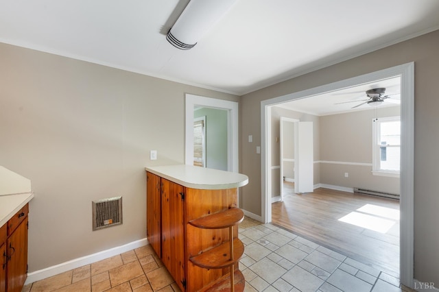 4550 Pumping Station Rd, Appomattox, VA 24522 - kitchen with baseboard heating, a peninsula, light countertops, crown molding, and brown cabinets