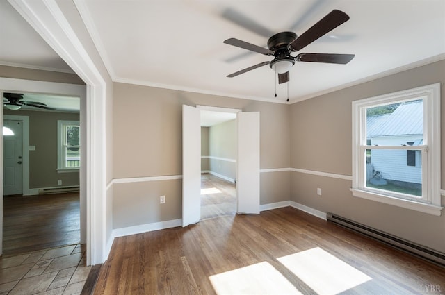 4550 Pumping Station Rd, Appomattox, VA 24522 - empty room with plenty of natural light, ceiling fan, a baseboard heating unit, wood finished floors, and ornamental molding