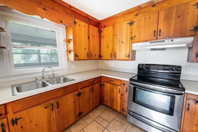 4550 Pumping Station Rd, Appomattox, VA 24522 - kitchen featuring under cabinet range hood, electric stove, light countertops, light tile patterned floors, and brown cabinets