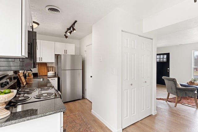 186 Dulwich Dr, Amherst, VA 24521 - kitchen with freestanding refrigerator, white cabinetry, light wood finished floors, dark stone countertops, and electric range oven