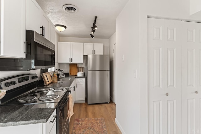 186 Dulwich Dr, Amherst, VA 24521 - kitchen with appliances with stainless steel finishes, white cabinets, light wood-type flooring, and dark stone counters