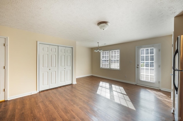 106 Colonnade St, Lynchburg, VA 24502 - unfurnished dining area with a chandelier, wood finished floors, and a textured ceiling