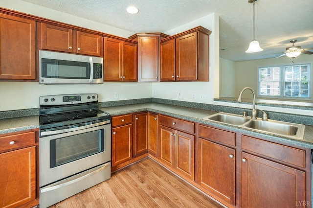 106 Colonnade St, Lynchburg, VA 24502 - kitchen with stainless steel appliances, light wood finished floors, dark countertops, ceiling fan, and pendant lighting