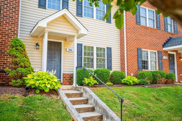 106 Colonnade St, Lynchburg, VA 24502 - doorway to property featuring brick siding and a lawn