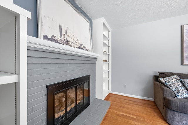1246 Rainbow Forest Dr, Lynchburg, VA 24502 - living room featuring a fireplace, wood finished floors, and a textured ceiling