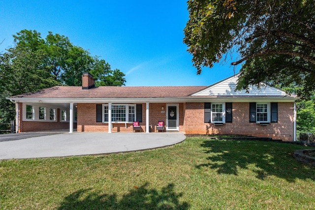 1246 Rainbow Forest Dr, Lynchburg, VA 24502 - ranch-style home with brick siding, a front yard, a chimney, concrete driveway, and a carport