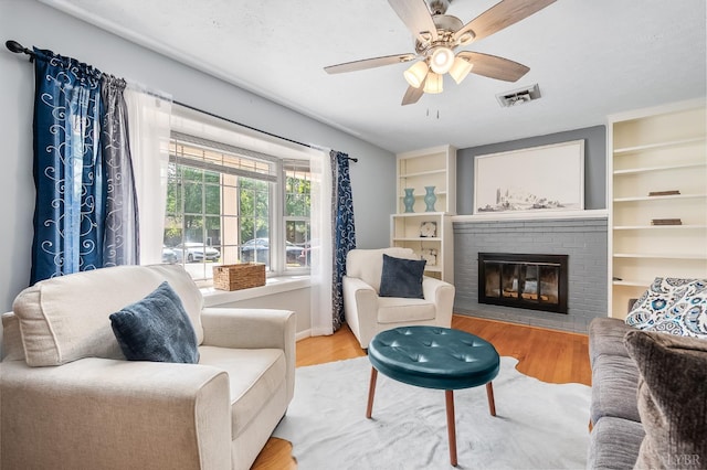 1246 Rainbow Forest Dr, Lynchburg, VA 24502 - living area with a brick fireplace, wood finished floors, a ceiling fan, and built in shelves