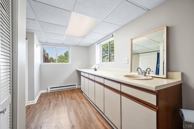 1246 Rainbow Forest Dr, Lynchburg, VA 24502 - full bathroom featuring a baseboard heating unit, a paneled ceiling, wood finished floors, and double vanity