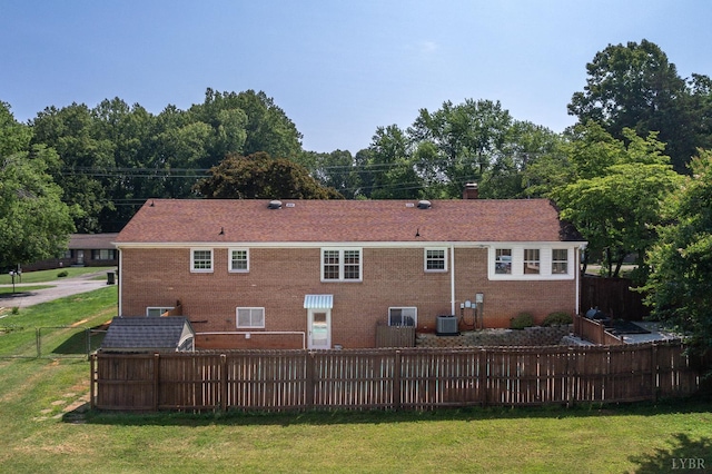 1246 Rainbow Forest Dr, Lynchburg, VA 24502 - rear view of house featuring a fenced backyard, a chimney, and brick siding