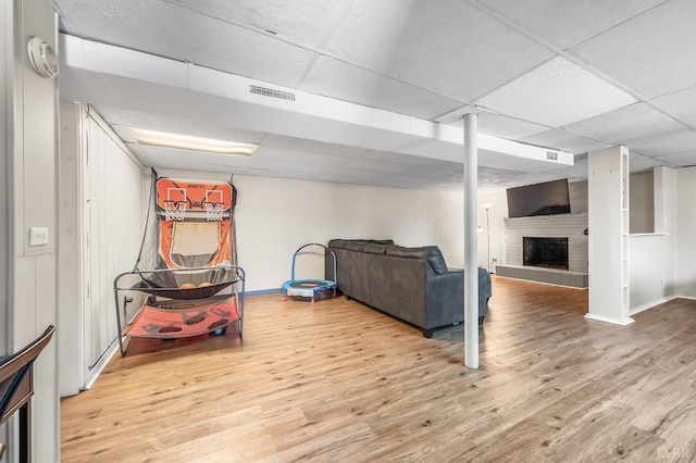 1246 Rainbow Forest Dr, Lynchburg, VA 24502 - finished below grade area featuring a paneled ceiling, wood finished floors, and a brick fireplace