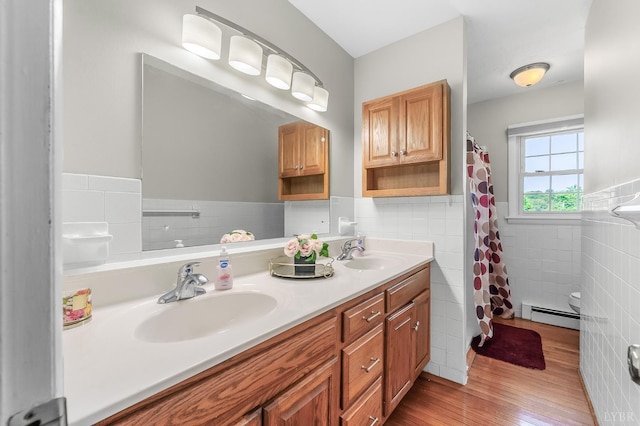 1246 Rainbow Forest Dr, Lynchburg, VA 24502 - full bathroom featuring tile walls, a baseboard radiator, wood finished floors, double vanity, and wainscoting