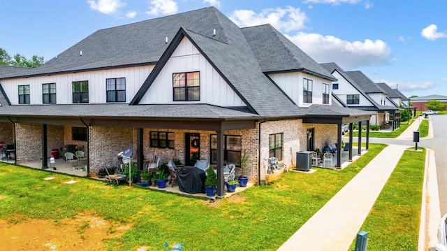 1010 Coles Ct, Forest, VA 24551 - rear view of house featuring a patio, brick siding, a lawn, and board and batten siding