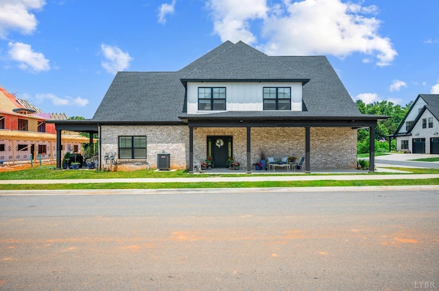 1010 Coles Ct, Forest, VA 24551 - view of front of home featuring a shingled roof, brick siding, and a porch