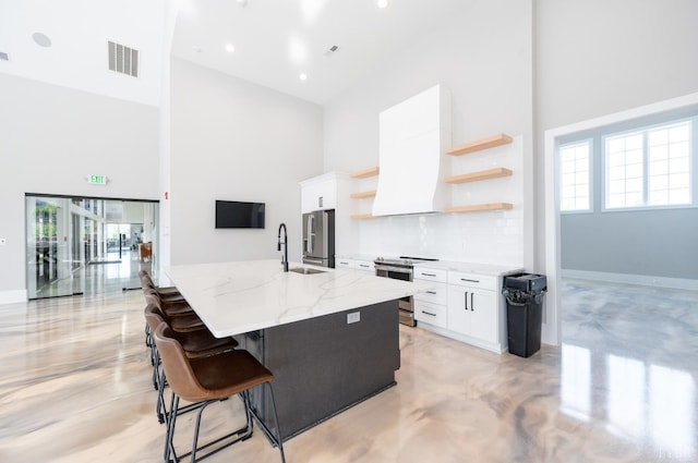 1010 Coles Ct, Forest, VA 24551 - kitchen featuring a towering ceiling, stainless steel appliances, open shelves, healthy amount of natural light, and white cabinetry