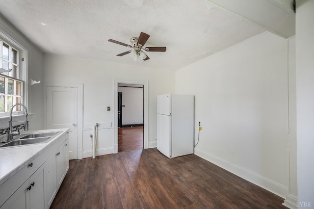 1614 Early St, Lynchburg, VA 24503 - kitchen with freestanding refrigerator, dark wood finished floors, light countertops, a ceiling fan, and white cabinets