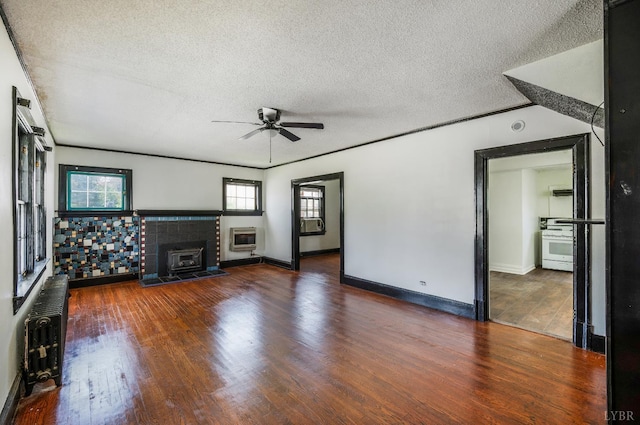 1614 Early St, Lynchburg, VA 24503 - unfurnished living room featuring heating unit, a ceiling fan, a textured ceiling, wood finished floors, and a fireplace
