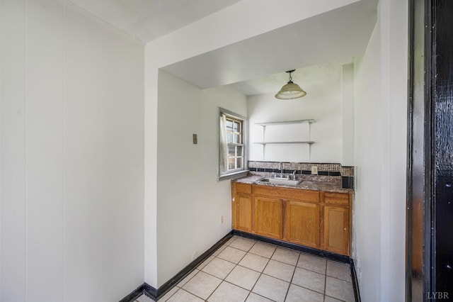 1614 Early St, Lynchburg, VA 24503 - kitchen with brown cabinets, light tile patterned floors, tasteful backsplash, and pendant lighting