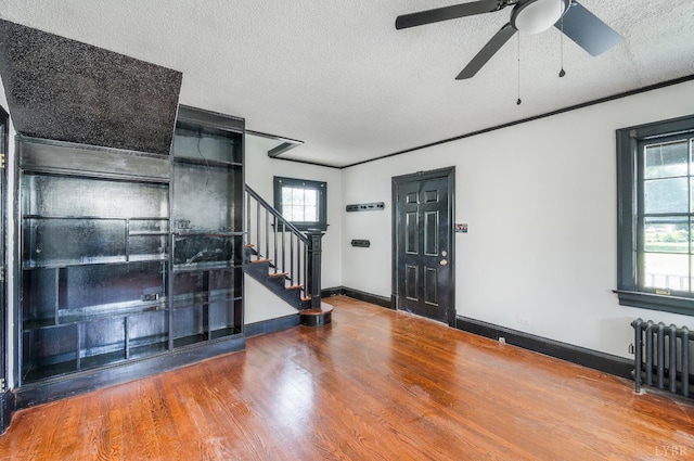 1614 Early St, Lynchburg, VA 24503 - entryway featuring radiator heating unit, stairs, a ceiling fan, a textured ceiling, and wood finished floors