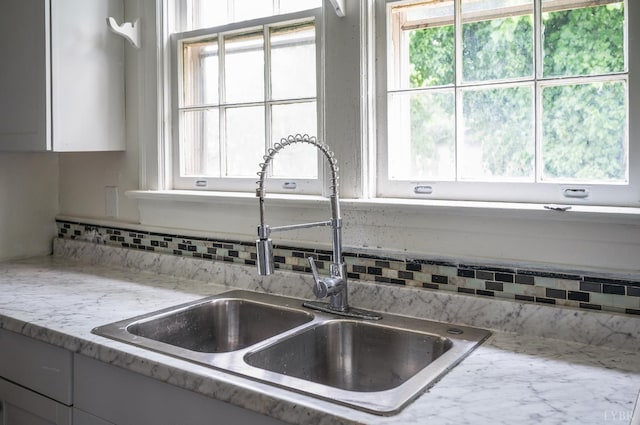 1614 Early St, Lynchburg, VA 24503 - kitchen view of decorative backsplash, light stone countertops, and white cabinetry