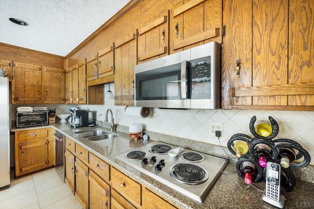 1159 Cifax Rd, Forest, VA 24551 - kitchen with appliances with stainless steel finishes, brown cabinetry, a textured ceiling, tasteful backsplash, and light tile patterned floors