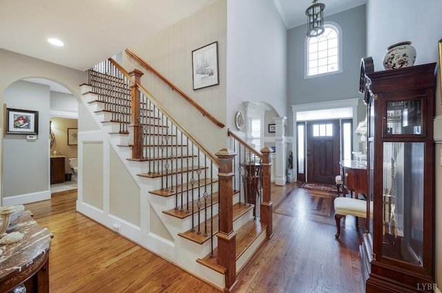 1424 Lake Manor Dr, Forest, VA 24551 - entryway featuring arched walkways, wood finished floors, stairs, ornamental molding, and a towering ceiling