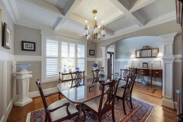 1424 Lake Manor Dr, Forest, VA 24551 - dining space with arched walkways, decorative columns, coffered ceiling, a chandelier, and wainscoting
