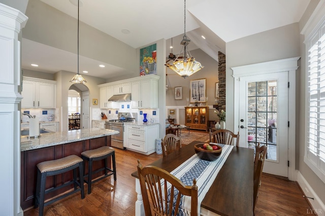 1424 Lake Manor Dr, Forest, VA 24551 - dining area featuring high vaulted ceiling, arched walkways, dark wood finished floors, a chandelier, and recessed lighting