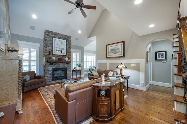 1424 Lake Manor Dr, Forest, VA 24551 - living area with ceiling fan, arched walkways, a fireplace, wood finished floors, and healthy amount of natural light