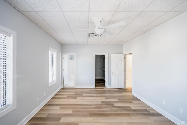1313 Enterprise, Lynchburg, VA 24502 - unfurnished bedroom featuring light wood-style flooring, a walk in closet, a drop ceiling, a closet, and ensuite bathroom