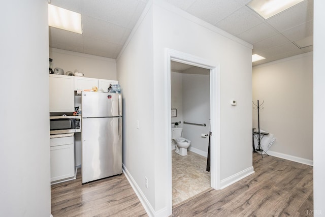 1313 Enterprise, Lynchburg, VA 24502 - kitchen with stainless steel appliances, light wood finished floors, ornamental molding, a paneled ceiling, and white cabinets
