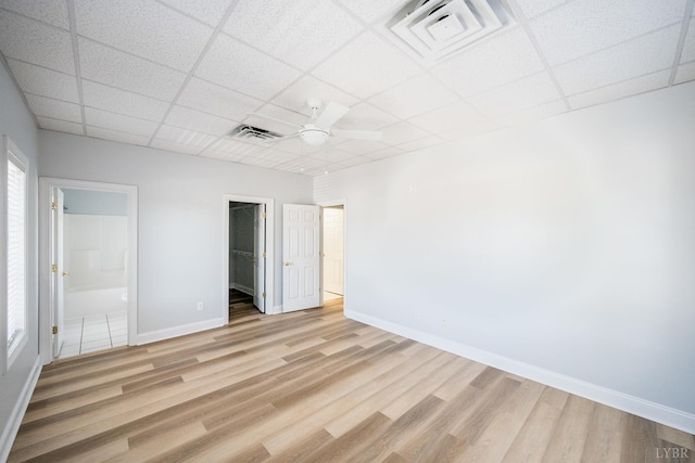 1313 Enterprise, Lynchburg, VA 24502 - unfurnished bedroom with a paneled ceiling, light wood-type flooring, a spacious closet, a closet, and connected bathroom
